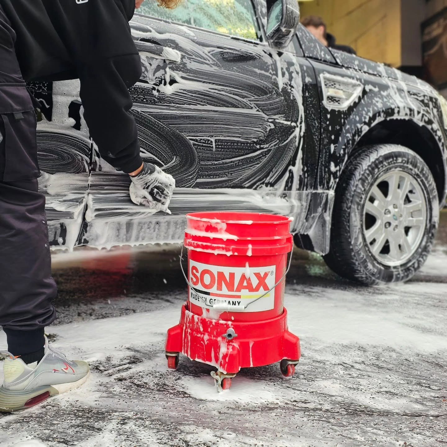 Sonax wash bucket and mitt in use during a professional eco-friendly mobile car valet