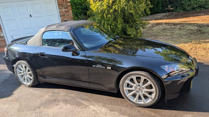 Black Honda S2000 with glossy paintwork on a driveway after a professional mobile valet