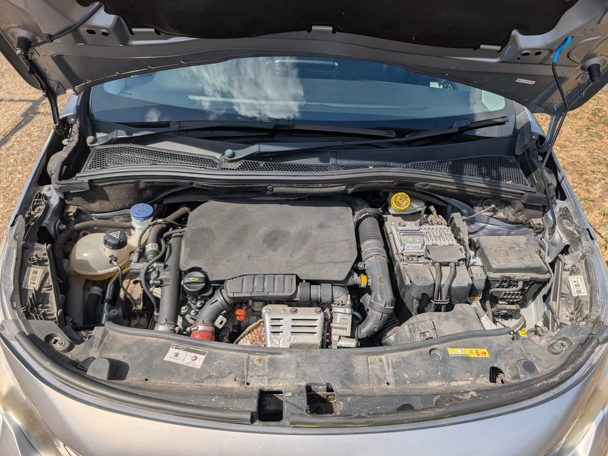 Peugeot engine bay before cleaning, dusty with grime buildup