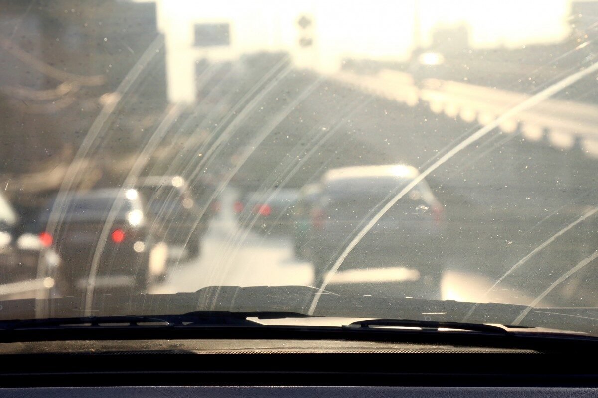 Greasy film and wiper smearing on car windscreen