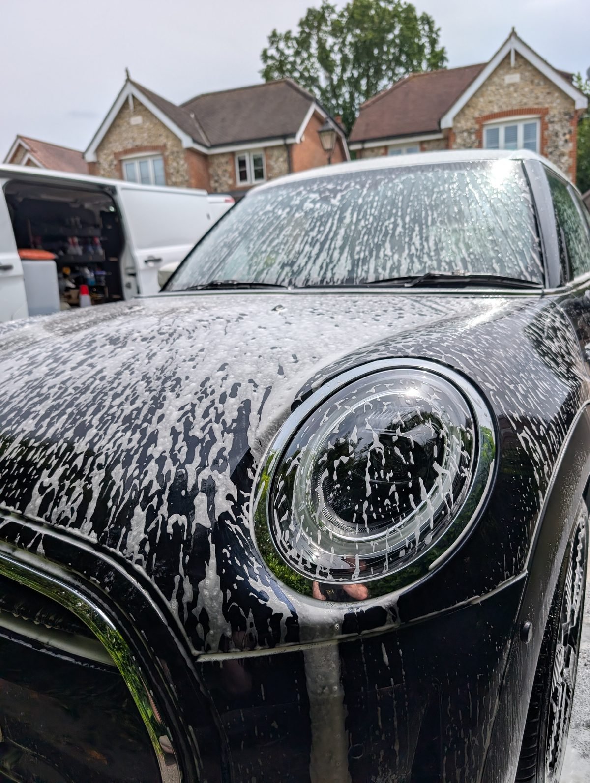 Black MINI covered in snow foam during a professional mobile valet in Beaconsfield