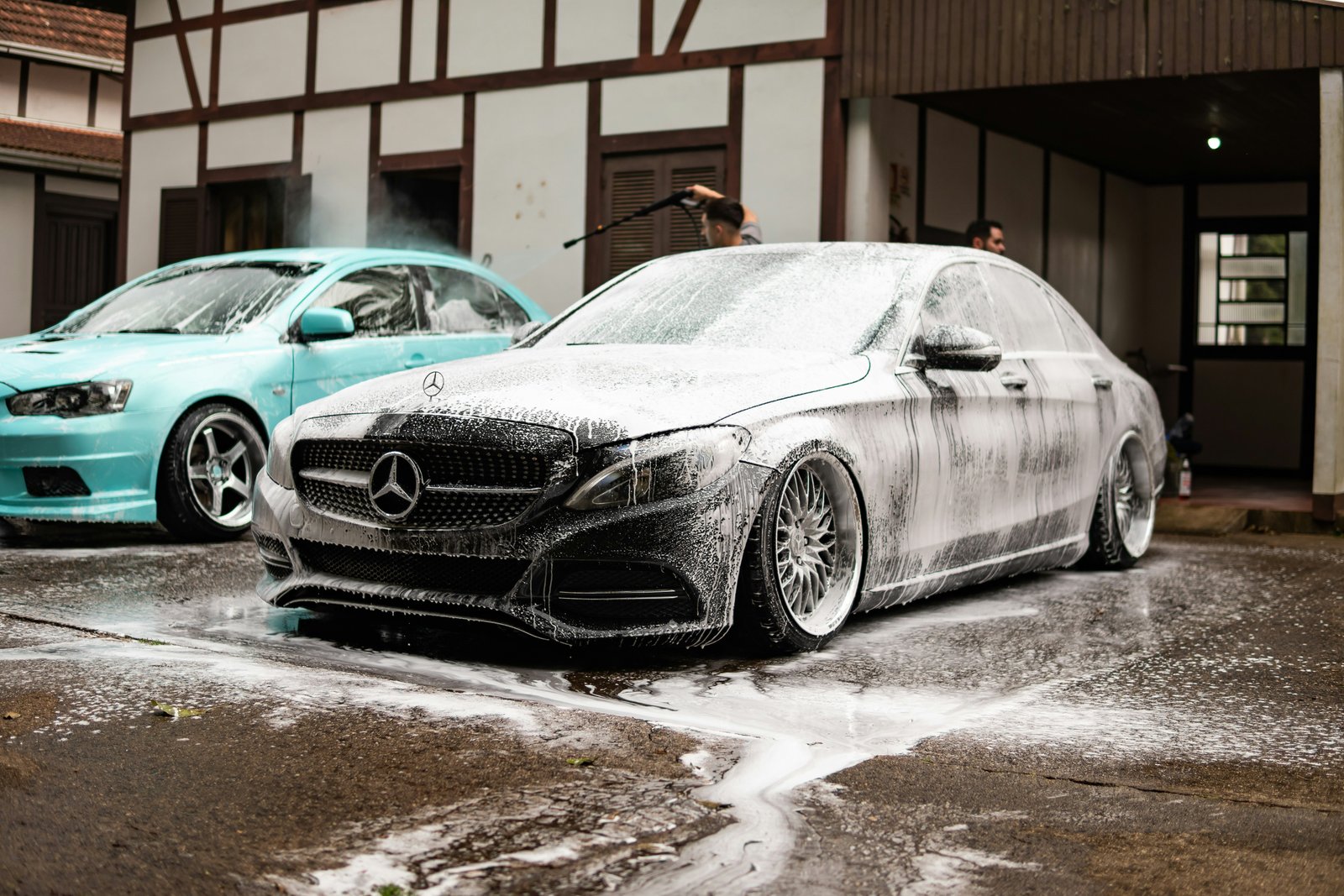 Car covered in snow foam during a professional hand wash