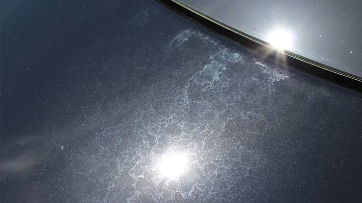 Water spot etching on dark car paint