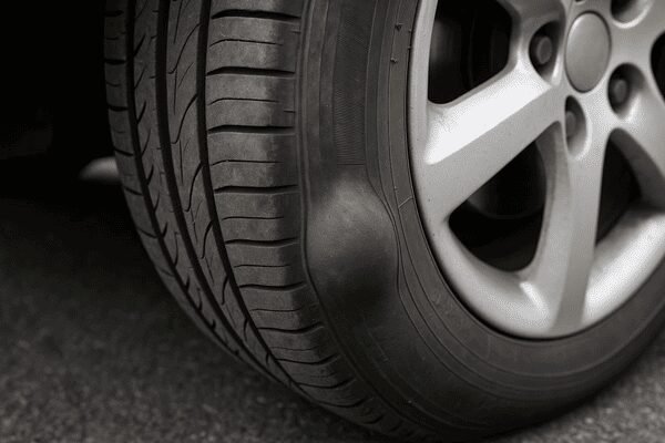 Bulge on tyre sidewall indicating internal damage