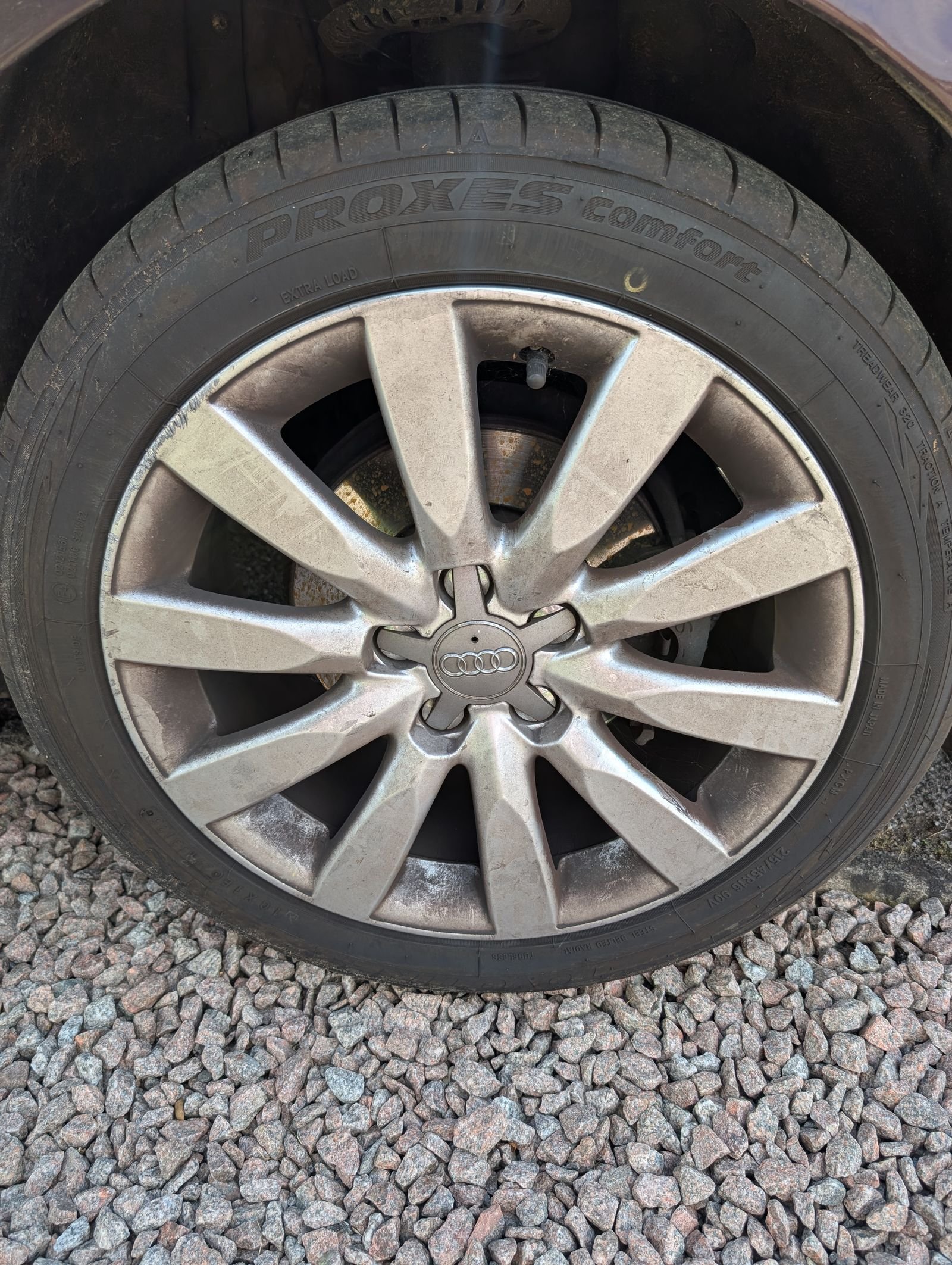 Audi alloy wheel before cleaning, covered in brake dust and grime