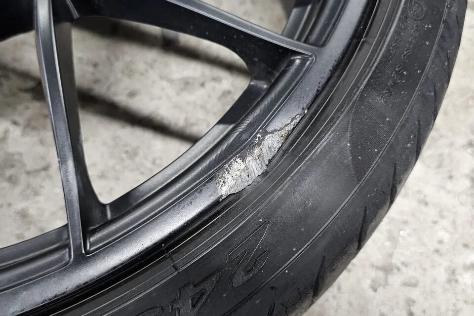 Kerb damage scuff on alloy wheel rim